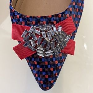 Slingback shoes with kitten heel and jewel accent.